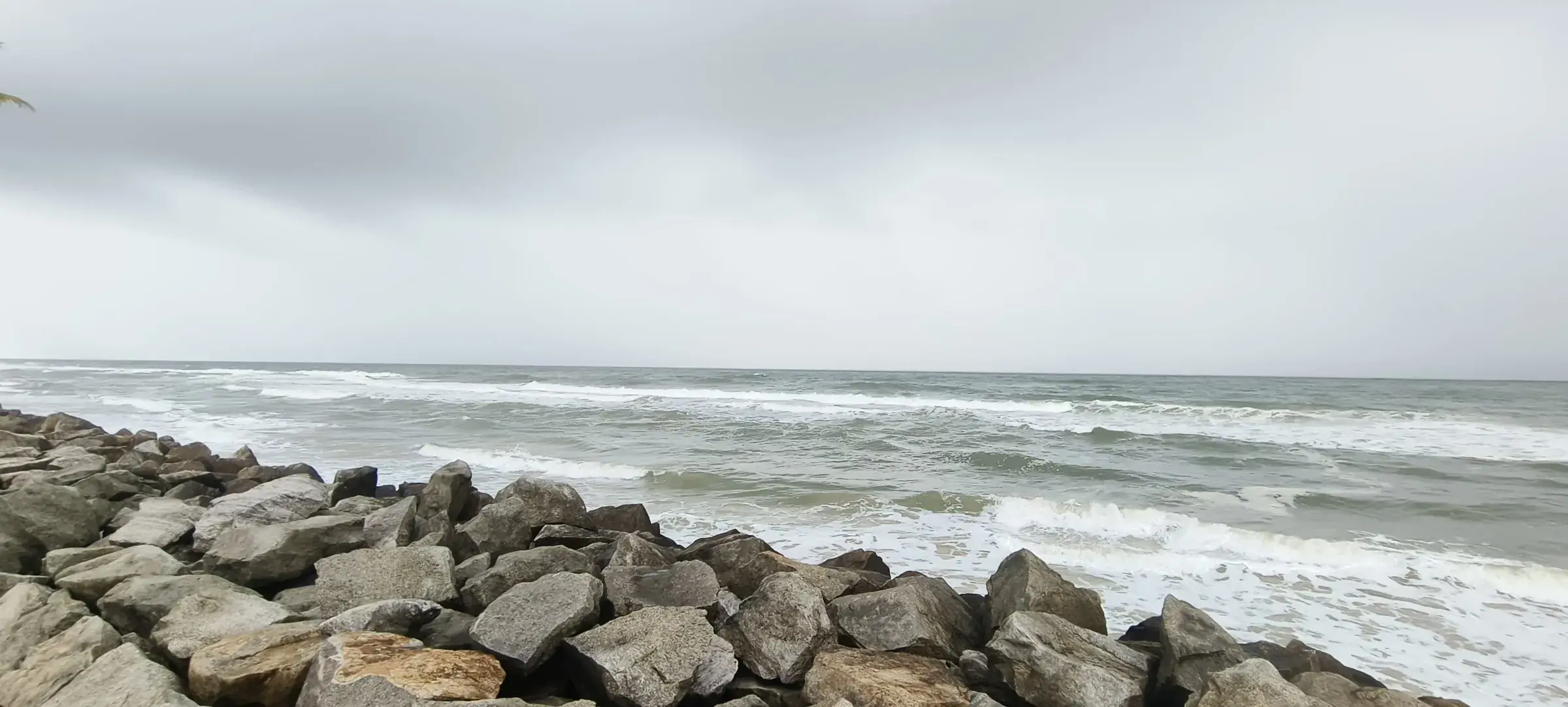 Waves breaking against the rocks at Kappil Beach