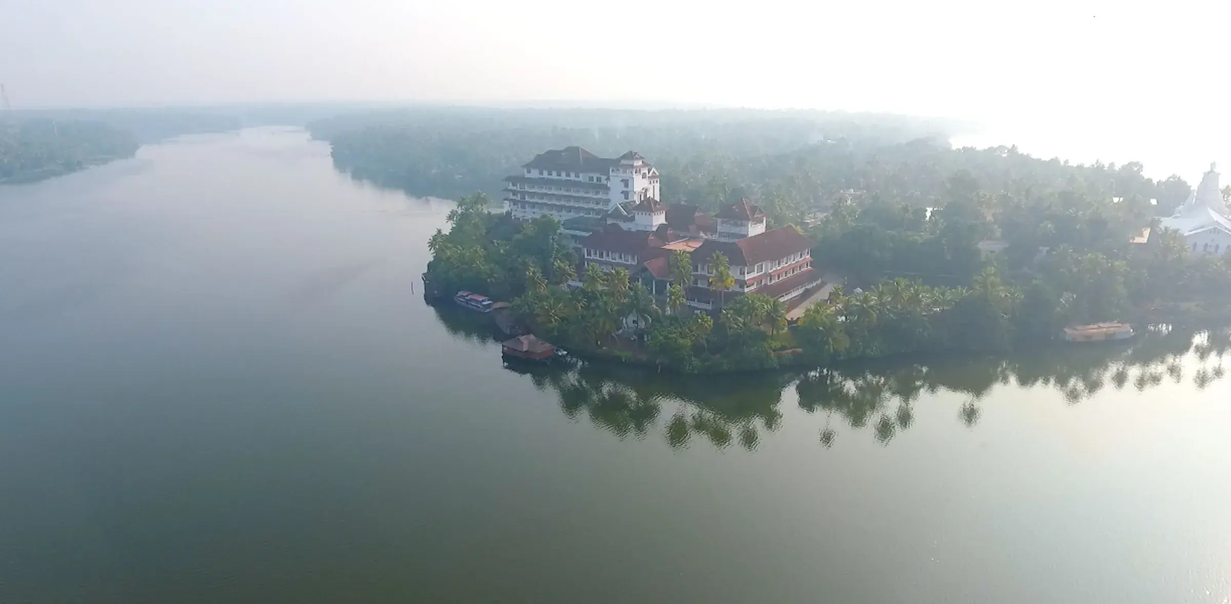 Calm waters and coconut palms on Ashtamudi Lake