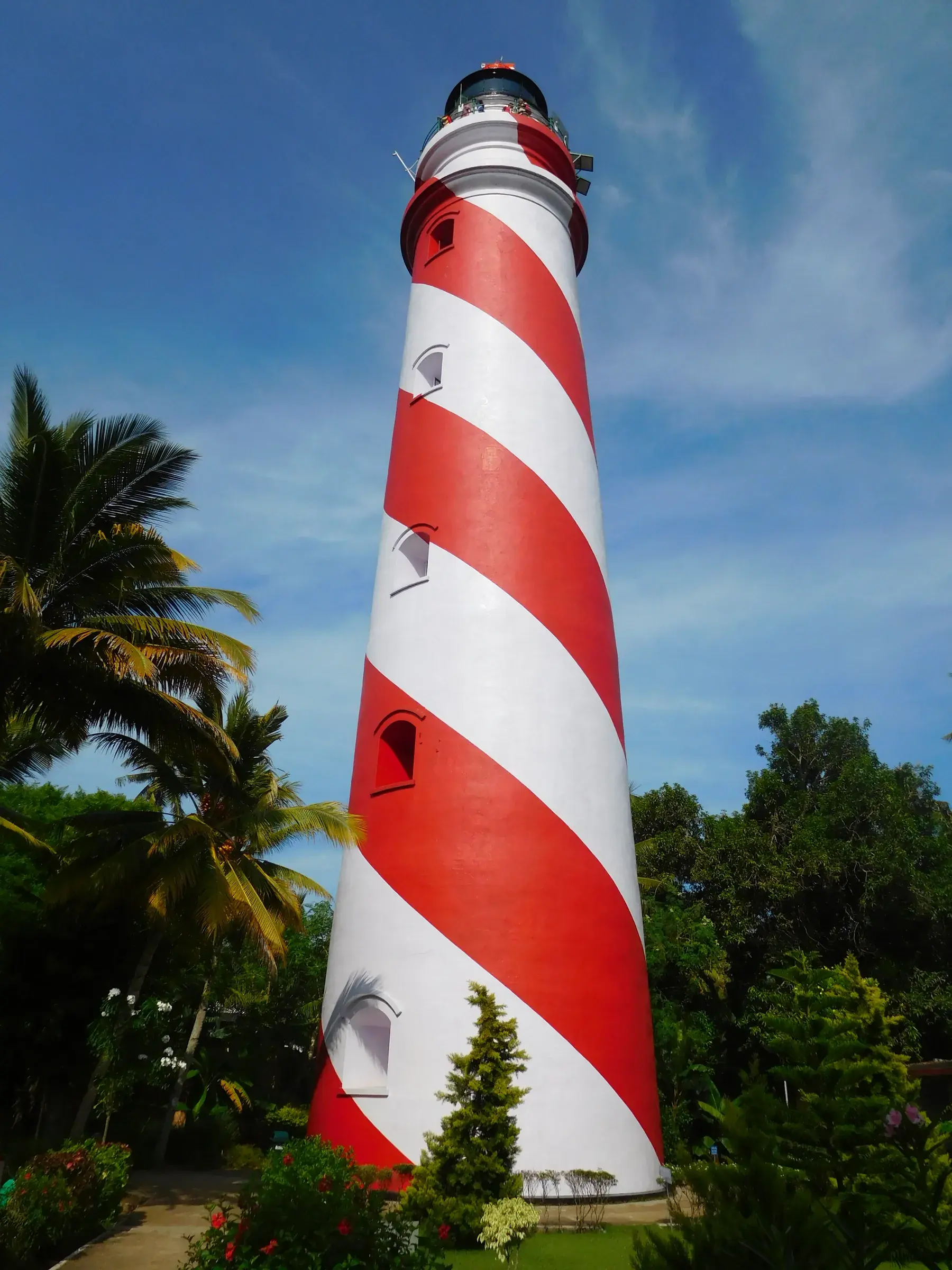 The tall red-and-white striped Thangassery lighthouse