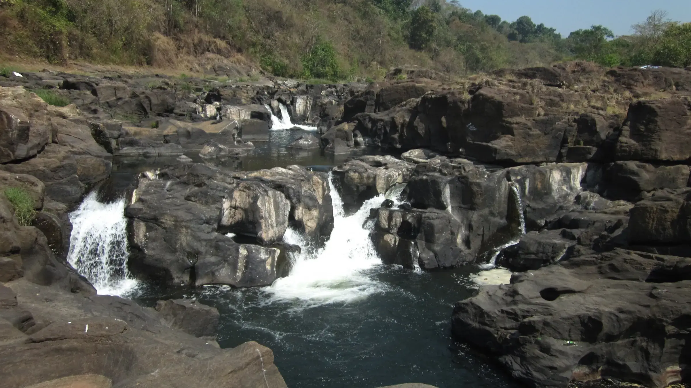 The Pamba river cascading over rocks at Perunthenaruvi