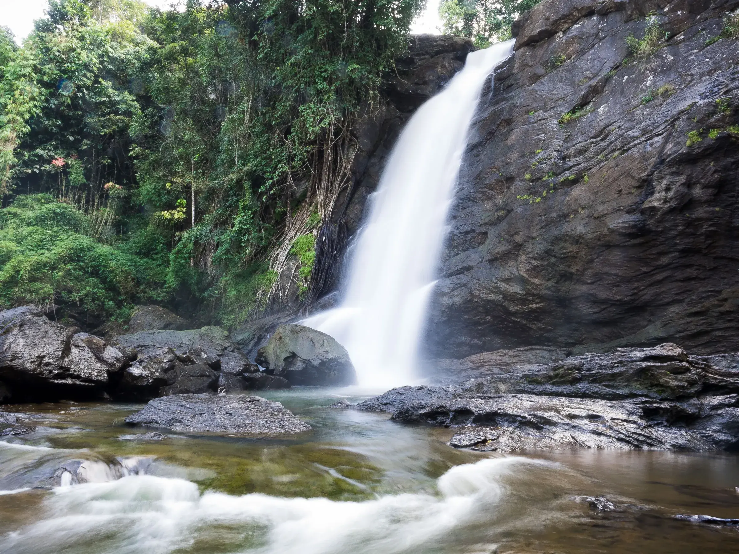 Water falling down a cliff at Soochipara Falls