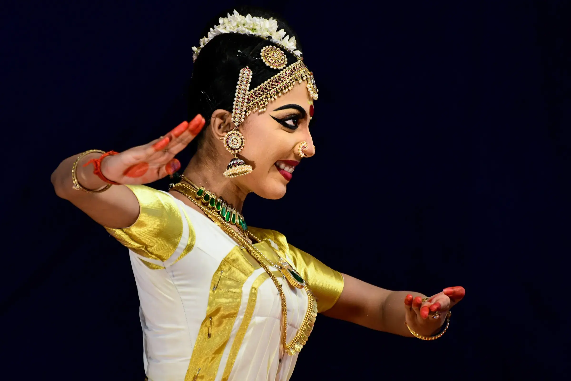A Mohiniyattam dancer in a white and gold costume