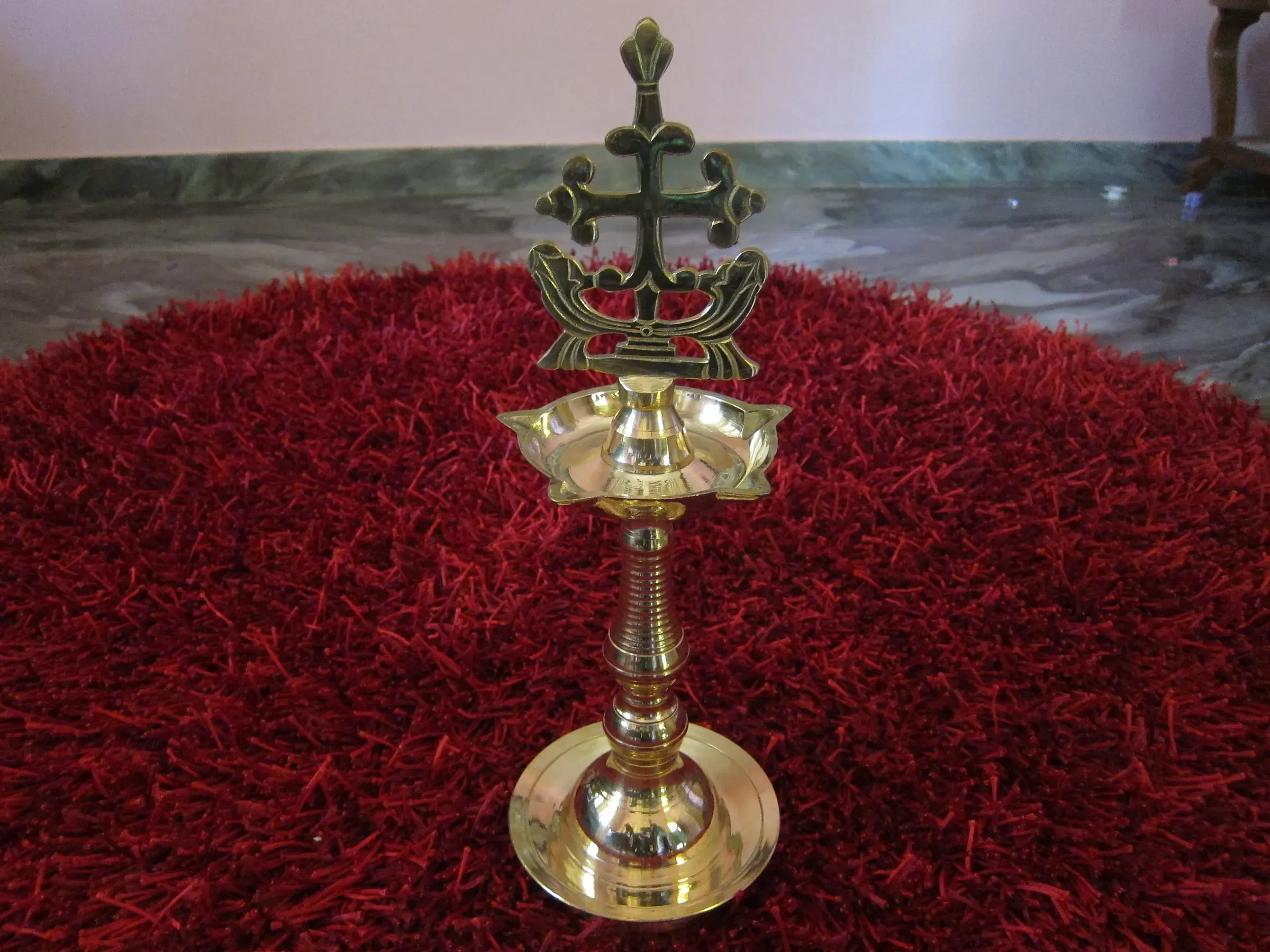 A brass nilavilakku oil lamp