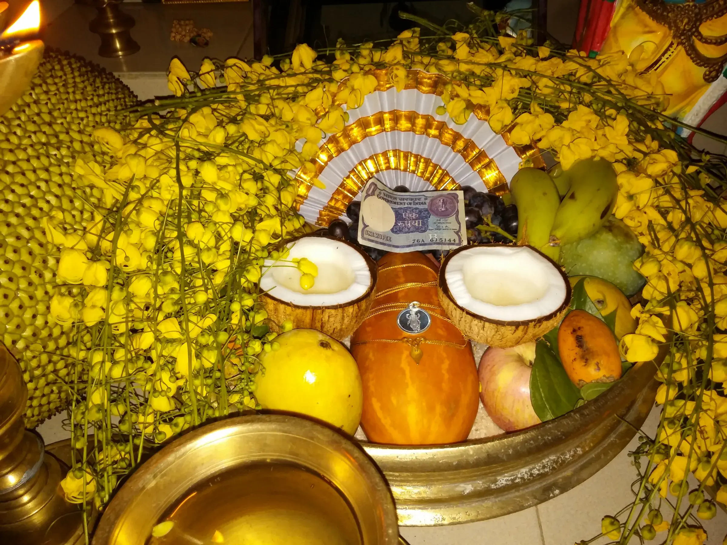 A Vishukkani arrangement of fruits, rice and a lamp